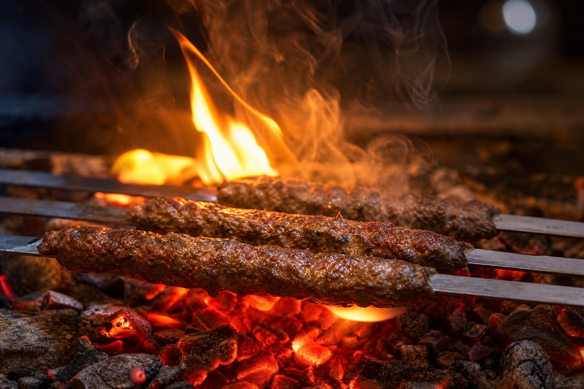 Turkish Adana kebabs on skewers over red-hot charcoal embers